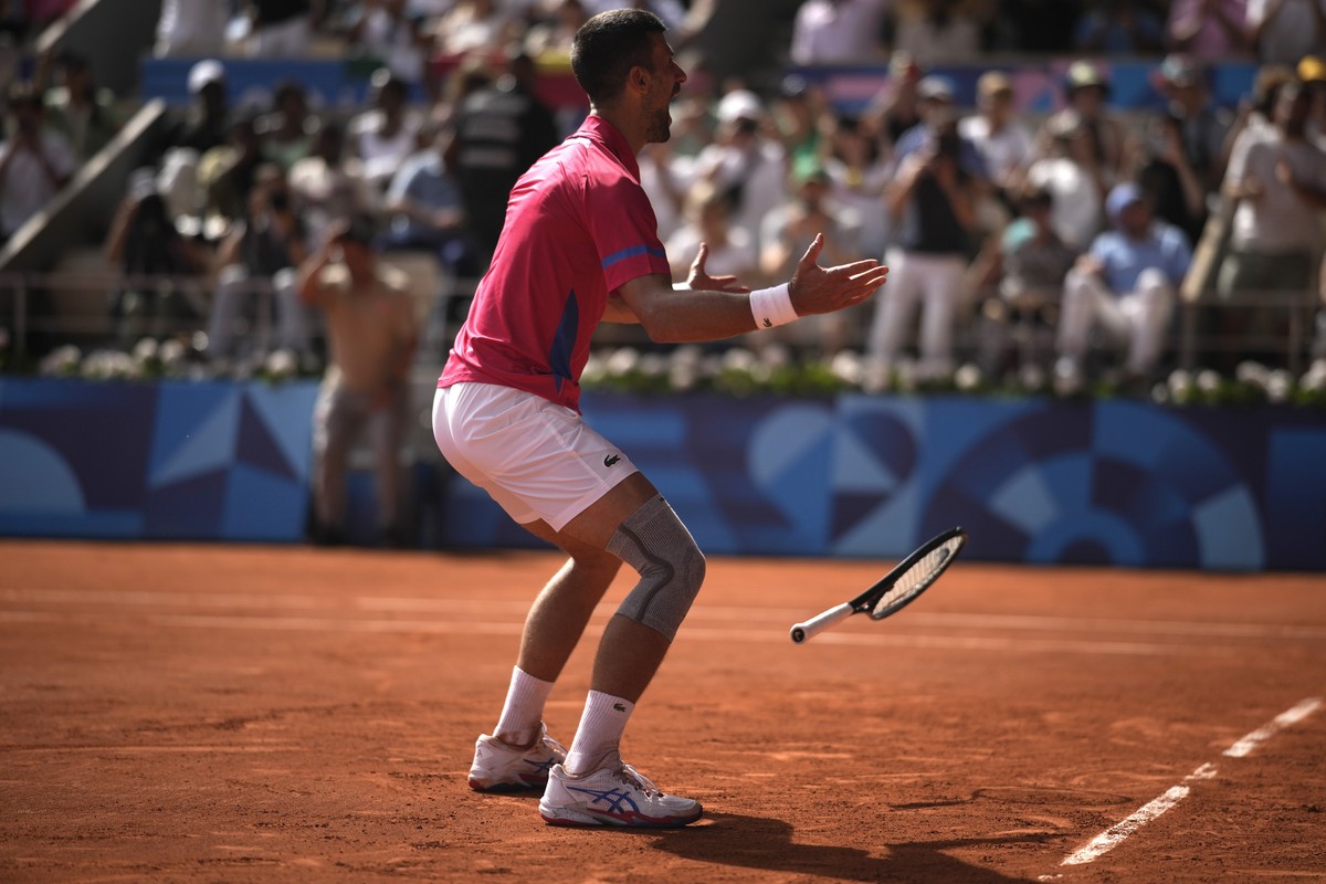 Serbia's Novak Djokovic reacts as he defeats Spain's Carlos Alcaraz during the men's singles tennis final at the Roland Garros stadium during the 2024 Summer Olympics, Sunday, Aug. 4, 2 ...