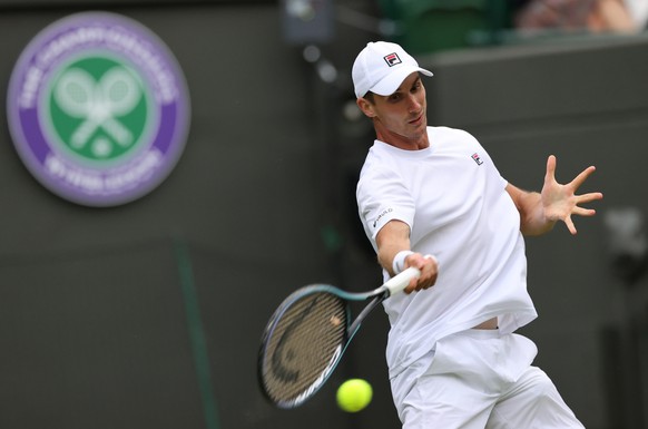 epa10039432 Alexander Ritschard of Switzerland in action in the men&#039;s first round match against Stefanos Tsitsipas of Greece at the Wimbledon Championships, in Wimbledon, Britain, 28 June 2022. E ...