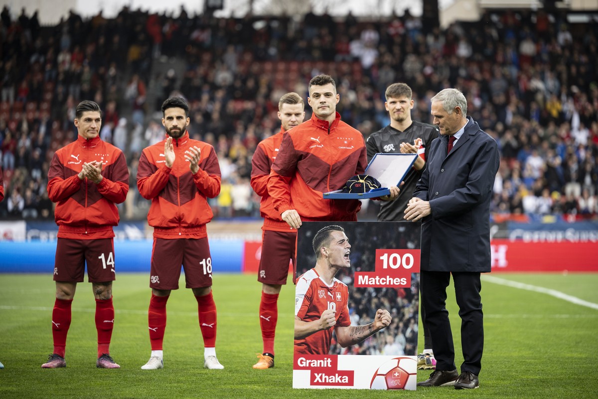 epa09858086 Switzerland's Granit Xhaka (C) receives a present for his 100th cap prior to the International Friendly soccer match between Switzerland and Kosovo in Zurich, Switzerland, 29 March 20 ...