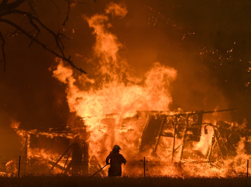 epa08087915 YEARENDER 2019 DECEMBER....NSW Rural Fire Service crews fight the Gospers Mountain Fire as it impacts a structure at Bilpin, in the Blue Mountains, west of Sydney, New South Wales (NSW), A ...