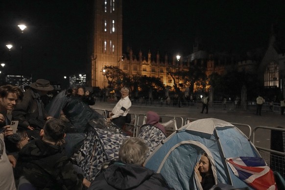 People camp out in front of Palace of Westminster on the eve of the funeral of Queen Elizabeth II in London, England, Sunday, Sept. 18, 2022. The funeral of Queen Elizabeth II, Britain's longest-reign ...