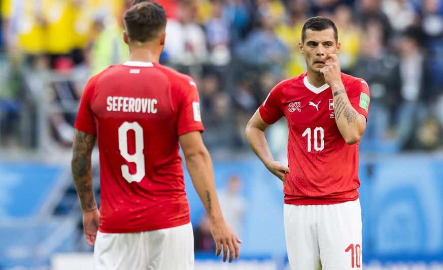 Switzerland's forward Haris Seferovic, left, and Switzerland's midfielder Granit Xhaka, right, react during the FIFA World Cup 2018 round of 16 soccer match between Sweden and Switzerland at the Krest ...