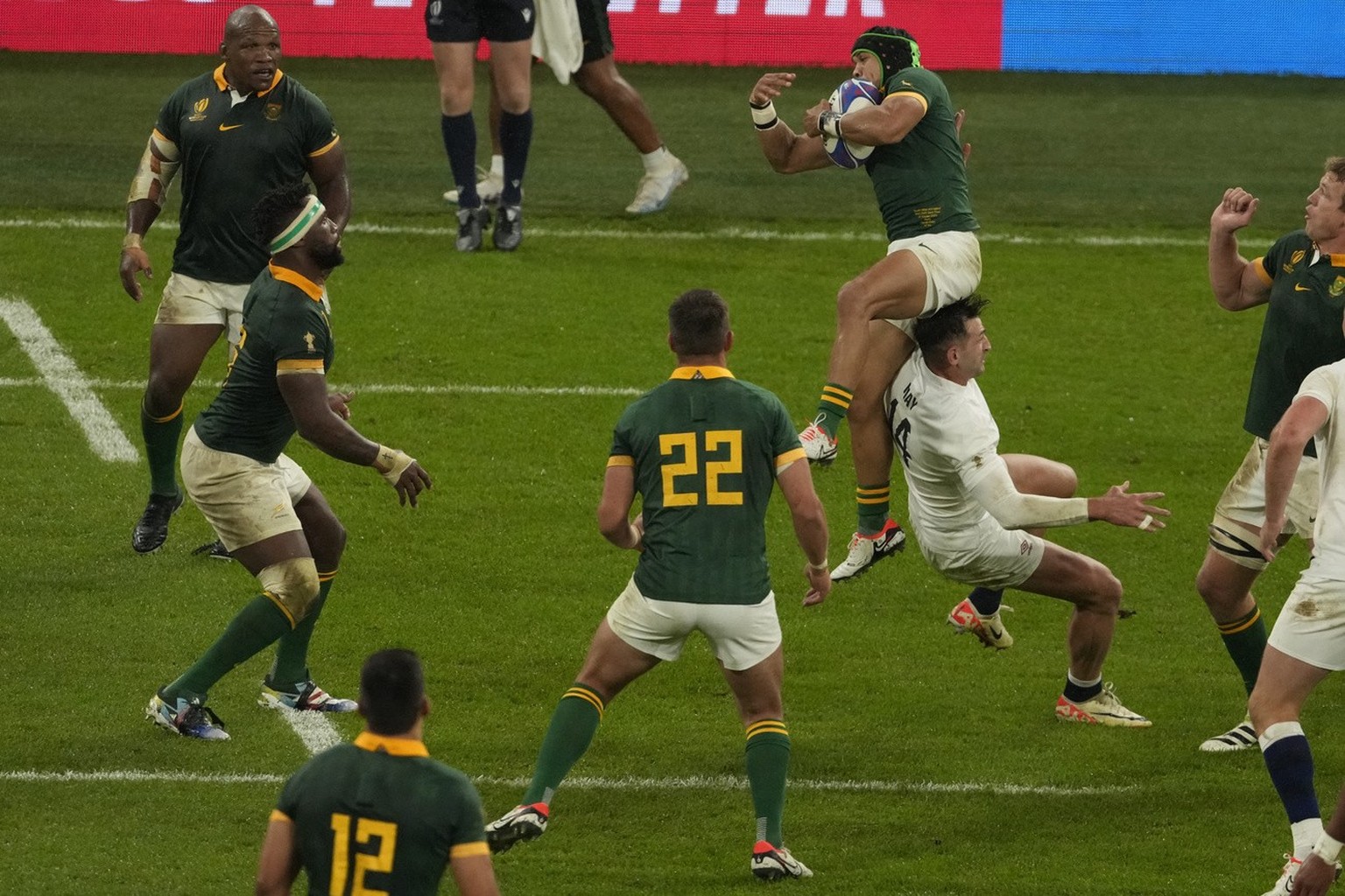 South Africa's Kurt-Lee Arendse collects a high ball as England's Jonny May runs into him during the Rugby World Cup semifinal match between England and South Africa at the Stade de France i ...