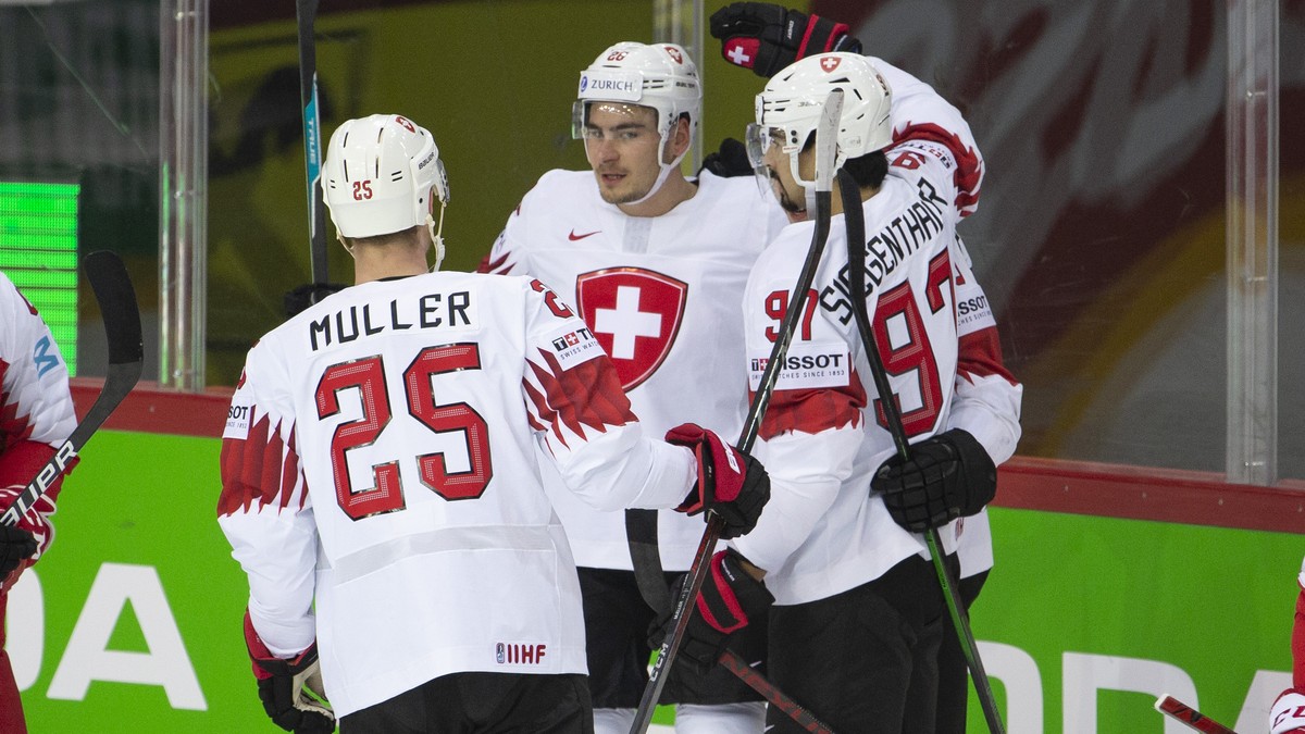 Switzerland's forward Timo Meier, center, celebrates his goal with teammates defender Mirco Mueller, left, and defender Jonas Siegenthaler, right, after scoring the 0:1, during the IIHF 2021 Worl ...