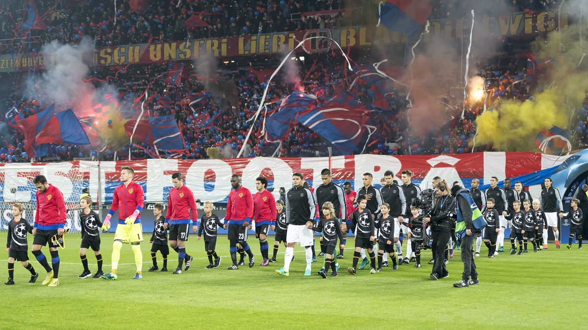 The teams enter the pitch prior to an UEFA Champions League Group stage Group A matchday 4 soccer match between Switzerland's FC Basel 1893 and France's Paris Saint-Germain Football Club, at ...