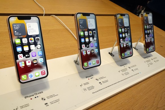 The line-up of the Apple iPhone 13 is displayed on their first day of sale, in New York, Friday, Sept. 24, 2021. They are, from left: iPhone 13 mini, iPhone 13, iPhone 13 Pro, and iPhone 13 Pro Max. ( ...