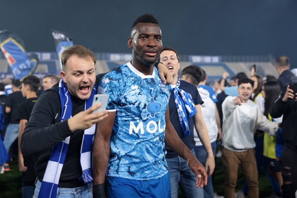Como, Italy, 10th May 2024. Jean-Pierre junior Nsame of Como celebrates promotion to Serie A with fans following the final whistle of the Serie B match at Stadio Giuseppe Sinigaglia, Como. Picture cre ...
