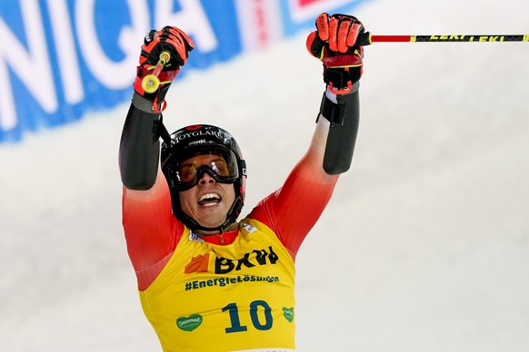 Switzerland's Gino Caviezel celebrates in the finish line of an alpine ski, men's World Cup giant slalom in Schladming, Austria, Wednesday, Jan. 25, 2023. (AP Photo/Giovanni Auletta)