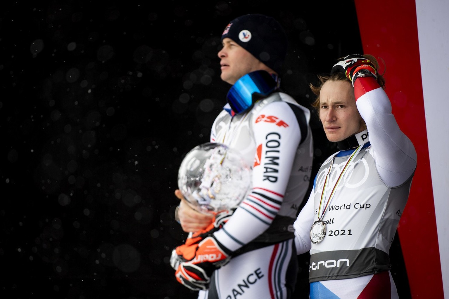 France&#039;s Alexis Pinturault celebrates with the crystal globe during the award ceremony of the men&#039;s overall world cup competition next to Marco Odermatt of Switzerland, right, at the FIS Alp ...