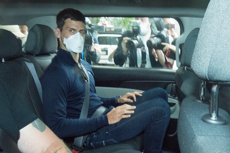 epa09688748 (FILE) - Serbian tennis player Novak Djokovic (C) departs from the Park Hotel government detention facility before attending a court hearing at his lawyers office in Melbourne, Australia,  ...