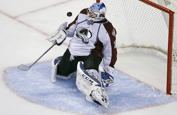 Colorado Avalanche goalie Reto Berra makes a save against the Boston Bruins in the third period of an NHL hockey game in Boston, Monday, Oct. 13, 2014. The Avalanche won 2-1. (AP Photo/Elise Amendola)