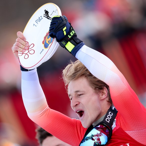 epa11849670 First placed Marco Odermatt of Switzerland poses on the podium after the Men's Super G race at the FIS Alpine Skiing World Cup in Kitzbuehel, Austria, 24 January 2025. EPA/ANNA SZILAG ...