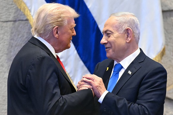 President Donald Trump talks with Israel&#039;s Prime Minister Benjamin Netanyahu at the Knesset, Israel&#039;s parliament, Monday, Oct. 13, 2025, in Jerusalem. (Saul Loeb/Pool via AP)
Trump Mideast W ...