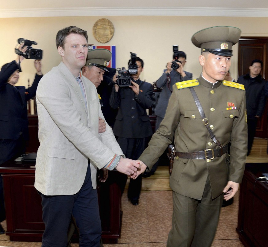 epa06026113 (FILE) - A file handout photo provided by the official Korean Central News Agency (KCNA)shows Otto Frederick Warmbier (L) in relation to his trial held by The Supreme Court of the Democrat ...