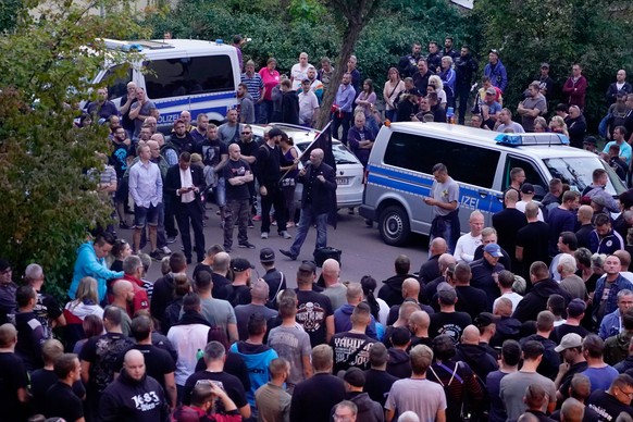 epa07009408 David Koeckert (C) of far-right organization &#039;Thuegida&#039; speaks after a so-called mourning march for a 22-year-old man who died in Koethen, Germany, 09 September 2018. On the nigh ...