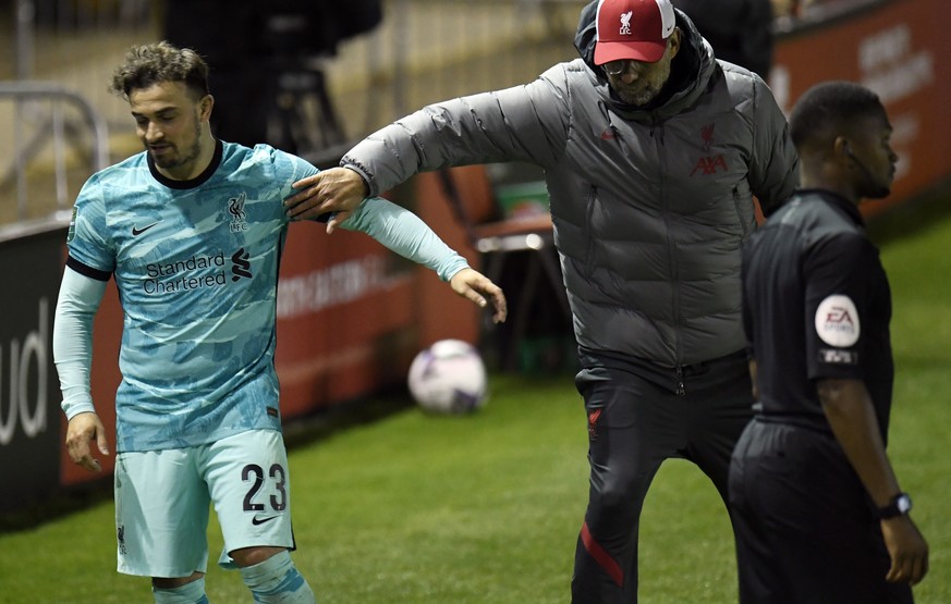 epa08694955 Liverpool manager Juergen Klopp (R) and Xherdan Shaqiri (L) react during the English Carabao Cup third round soccer match between Lincoln City and Liverpool FC in Lincoln, Britain, 24 Sept ...