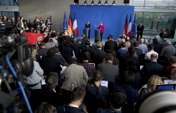 French President Emmanuel Macron, centre left, and German Chancellor Angela Merkel face the media during a press conference in Berlin, Germany, Monday, May 15, 2017. Macron and Merkel pledged Monday t ...