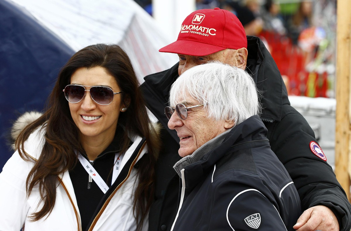 Formula One Chief Executive Bernie Ecclestone (R), his wife Fabiana Flosi and Former Formula One champion Niki Lauda pose for a picture during the men's Alpine Skiing World Cup downhill race in K ...