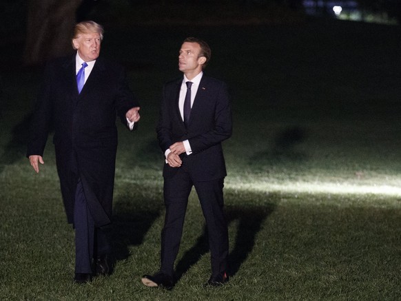 epa06688152 US President Donald J. Trump (L), French President Emmanuel Macron (2-L), First Lady Melania Trump (R) and French First Lady Brigitte Macron (2-R) walk to the White House after step off Ma ...