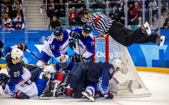 epaselect The referee hoists himself up on the net during the mens preliminary round match between USA and Slovakia at the Gangneung Hockey Centre at the PyeongChang Winter Olympic Games 2018, in Gang ...