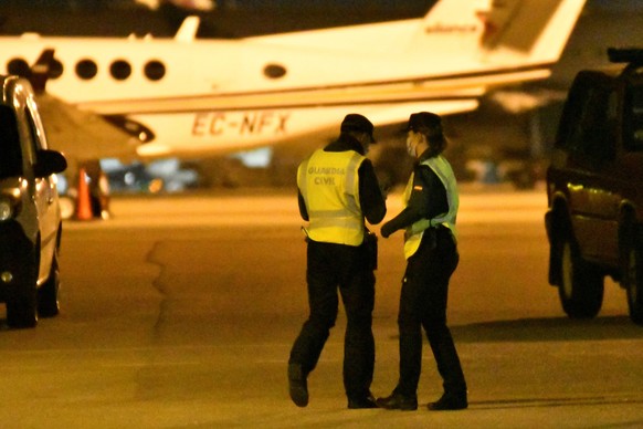 epa09567196 Two Spanish Civil Guards at Palma de Mallorca airport search the runways for a group of passengers who fled from an international flight after a medical emergency landing between Morocco a ...