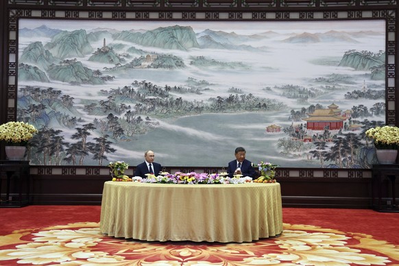 Russian President Vladimir Putin, left, speaks with Chinese President Xi Jinping during their meeting at The Great Hall of the People in Beijing, China, Tuesday, Sept. 2, 2025. (Alexander Kazakov, Spu ...