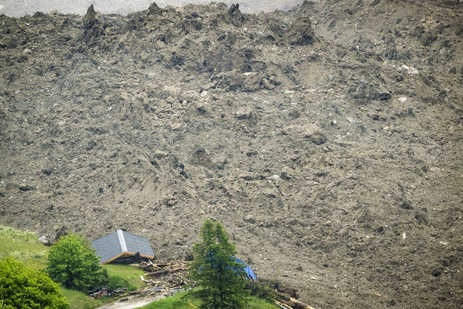 A large avalanche with a mixture of ice, rock, snow and water reach the valley floor is pictured in Wiler after the Birch glacier collapsing above Blatten, Switzerland, Wednesday, May 28, 2025. A larg ...