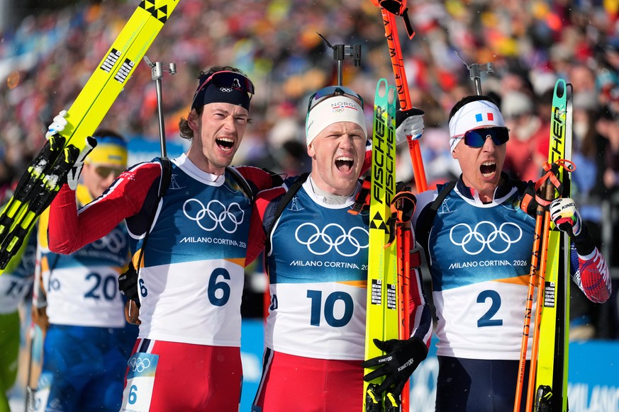 Silver medalist Sturla Holm Laegreid, of Norway, from left, gold medalist Johannes Dale-Skjevdal, of Norway, and Bronze medalist Quentin Fillon Maillet, of France, pose for photos after the men's ...