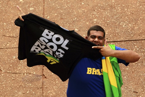 A supporter shows a T-shirt with the name of the Brazil&#039;s President-elect Jair Bolsonaro, prior to Bolsonaro&#039;s Tuesday&#039;s inauguration ceremony, in Brasília, Brazil, Monday, Dec. 31, 201 ...