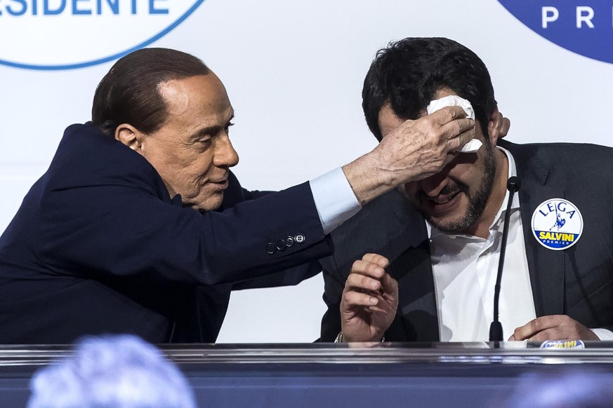 epa06572932 Forza Italia&#039;s Silvio Berlusconi (L) whipes the forehead of League&#039;s Matteo Salvini (R) during a media event for center-right parties leaders ahead of the general elections, in R ...