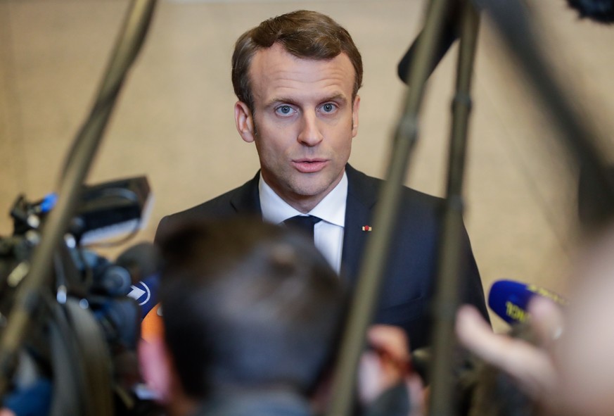 epa07497794 French President Emmanuel Macron (C) speaks to the press after a special EU summit on Brexit at the European Council in Brussels, Belgium, 11 April 2019. EU leaders gathered for an emergen ...