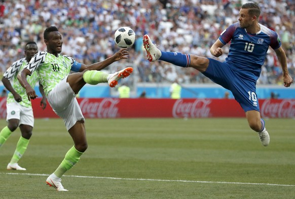 Nigeria&#039;s John Obi Mikel, left, and Iceland&#039;s Gylfi Sigurdsson compete for the ball during the group D match between Nigeria and Iceland at the 2018 soccer World Cup in the Volgograd Arena i ...