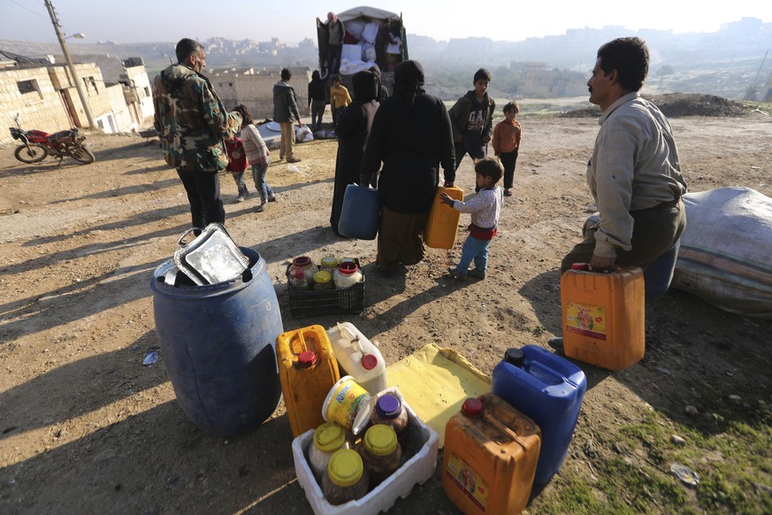 People carry supplied to a truck as they flee Maaret al-Numan, Syria, ahead of a government offensive Sunday, Dec. 22, 2019. Syrian government forces pushed deeper in their offensive on the last remai ...