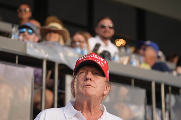 Republican presidential candidate former President Donald Trump watches play at the 18th hole in the final round of LIV Golf Miami, at Trump National Doral Golf Club, Sunday, April 7, 2024, in Doral,  ...