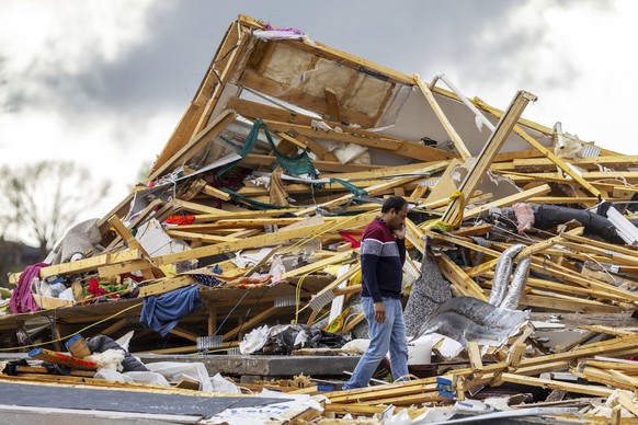 Gopala Penmetsa walks past his house after it was leveled by a tornado near Omaha, Neb., on Friday, April 26, 2024. (Chris Machian/Omaha World-Herald via AP)
