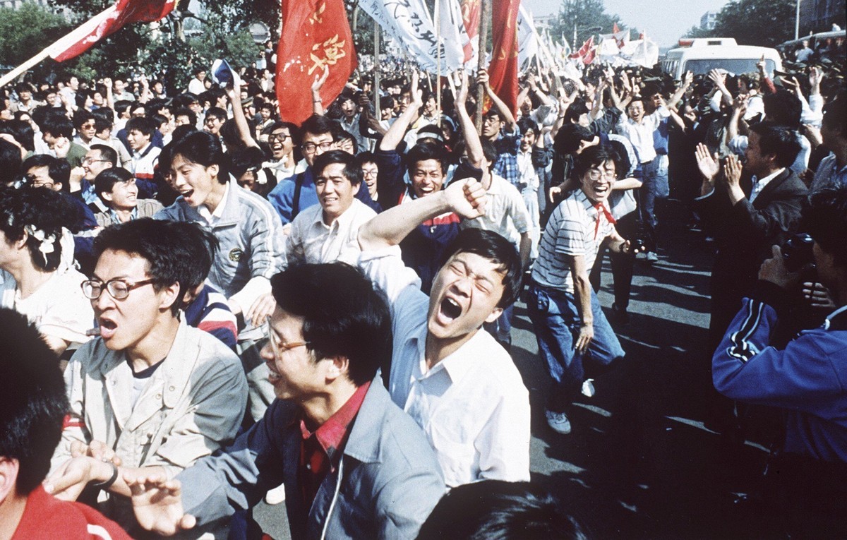 File - Chinese students shout after breaking through a police blockade during a pro-democracy march to Tiananmen Square, Beijing, May 4, 1989. Colleges and universities have long been protected places ...
