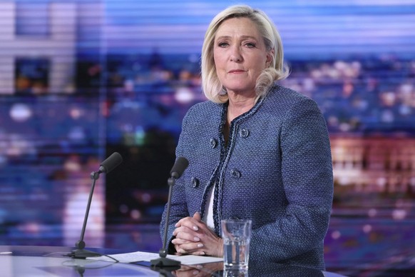 Far-right leader Marine Le Pen poses prior to an interview on the evening news broadcast of French TV channel TF1, after a French court convicted Marine Le Pen of embezzlement and barred her from seek ...
