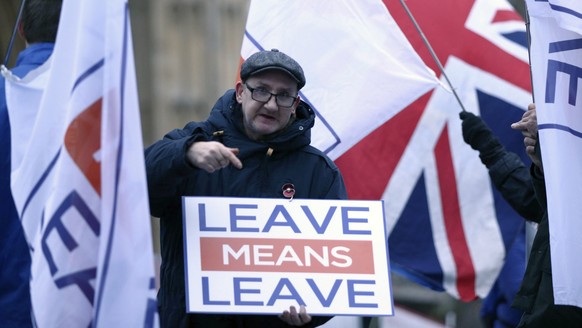 Pro-Brexit demonstrators wave flags and signs alongside anti-Brexit demonstrators, outside Parliament in London Monday Jan. 7, 2019. Parliament is expected to vote on Prime Minister Theresa May&#039;s ...