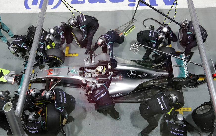 Mercedes driver Lewis Hamilton of Britain stops for a tire change in pit lane during the Singapore Formula One Grand Prix on the Marina Bay City Circuit Singapore, Sunday, Sept. 18, 2016. (AP Photo/Wo ...