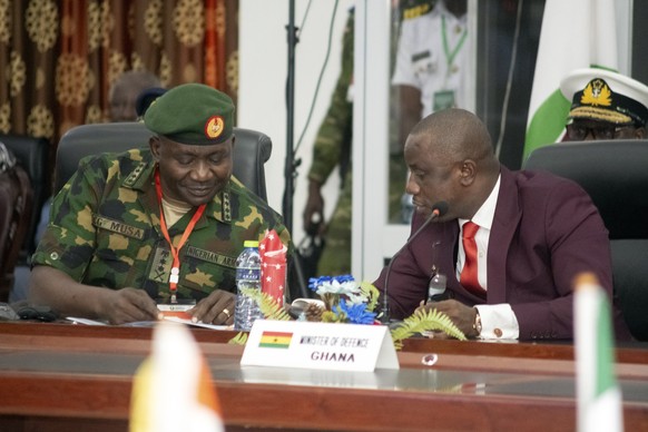 Ghana Defence Minister Dominic Aduna Bingab Nitiwu, right, confers with Nigerian Chief of Defence Staff General Christopher Gwabin Musa during the Extraordinary Meeting of the ECOWAS Committee of Chie ...