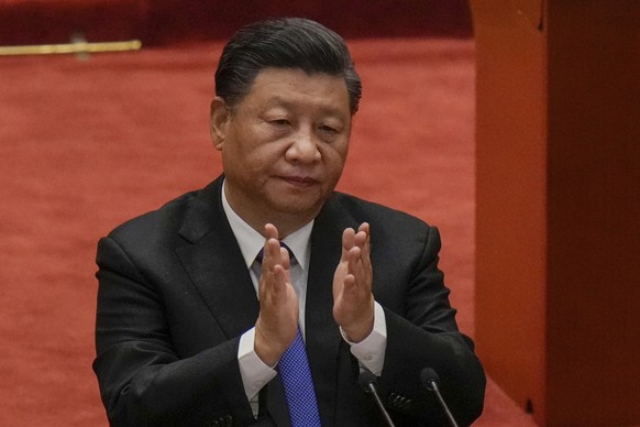 Chinese President Xi Jinping applauds during an event commemorating the 110th anniversary of Xinhai Revolution at the Great Hall of the People in Beijing, Saturday, Oct. 9, 2021. Xi said on Saturday r ...