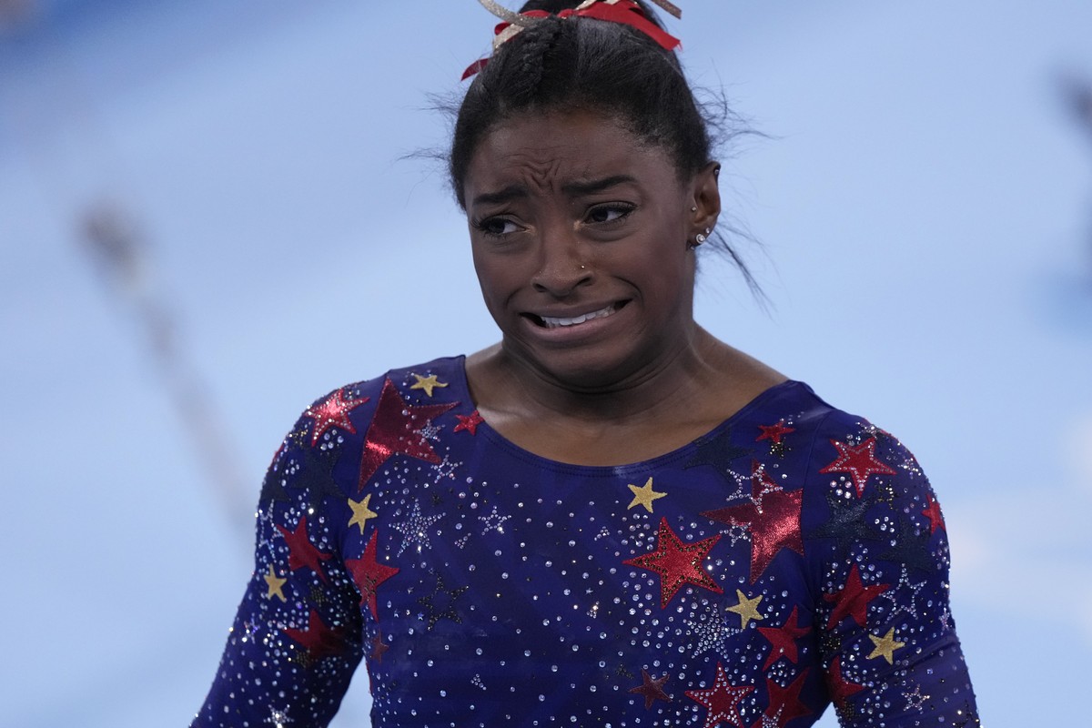 Simone Biles, of the United States, reacts after performing on the uneven bars during the women's artistic gymnastic qualifications at the 2020 Summer Olympics, Sunday, July 25, 2021, in Tokyo. ( ...