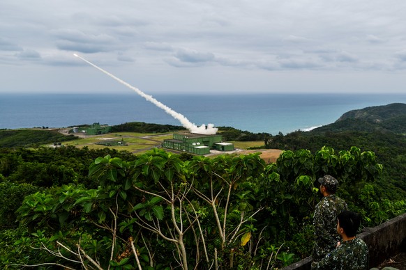 epa12569261 Taiwanese military personnel observe as a rocket flies out of a High Mobility Artillery Rocket System (HIMARS) during a drill in Pingtung, Taiwan, 12 May 2025. EPA/RITCHIE B. TONGO