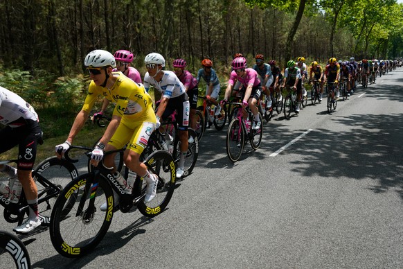 Slovenia's Tadej Pogacar, wearing the overall leader's yellow jersey, rides with the pack during the seventh stage of the Tour de France cycling race over 175.1 kilometers (108.7 miles) with ...