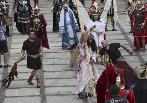 Residents reenact the crucifixion of Jesus Christ in the Passion Play of Iztapalapa, outside the Cathedral, on the outskirts of Mexico City, Friday, April 2, 2021, amid the new coronavirus pandemic. T ...