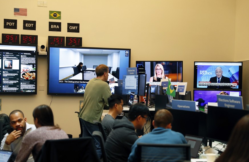 epa07101877 Facebook employees in the war room at Facebook in Menlo Park, California, USA, 17 October 2018 (issued 18 October 2018). Employees monitor election related content on the Facebook platform ...