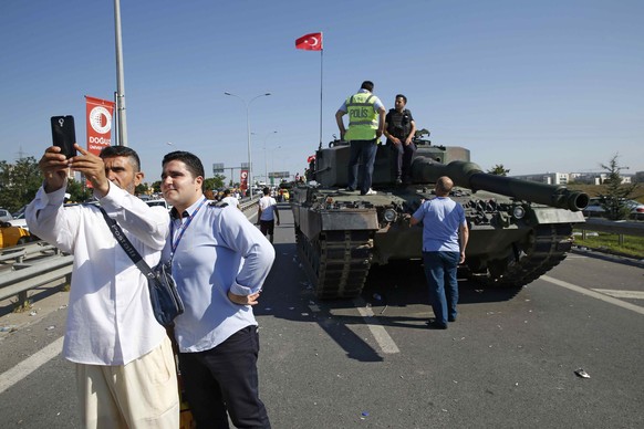 A man takes a selfie next to a military vehicle in front of Sabiha Airport, in Istanbul, Turkey July 16, 2016. REUTERS/Baz Ratner