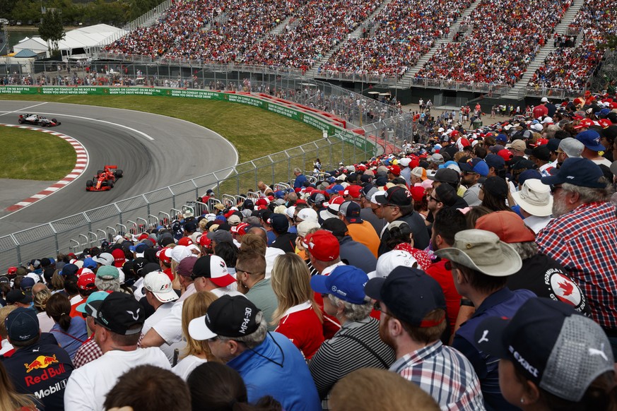 epa08348972 (FILE) Fans watch German Formula One driver Sebastian Vettel of Scuderia Ferrari (R) and Danish Formula One driver Kevin Magnussen of Haas F1 Team (L) in action during the 2018 Canada Form ...