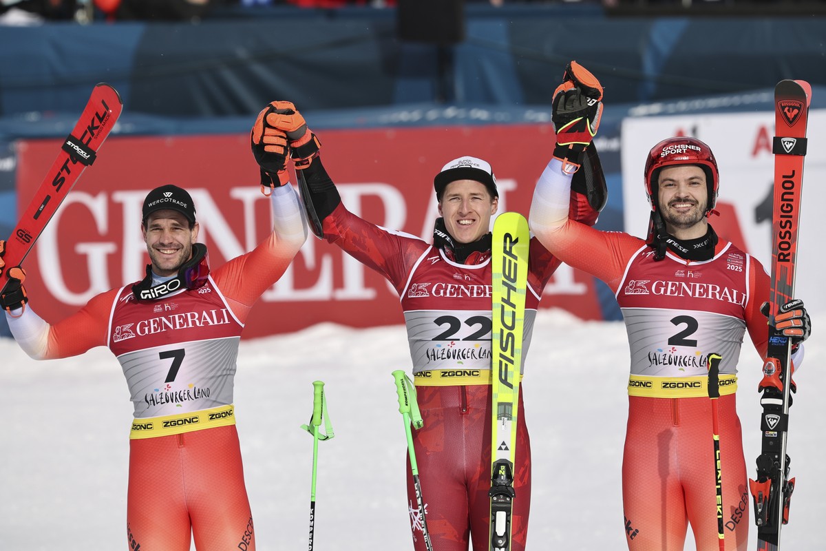 Austria's Raphael Haaser, center, winner of a gold medal in a men's giant slalom, celebrates with silver medalist Switzerland's Thomas Tumler, left, and bronze medalist Switzerland' ...