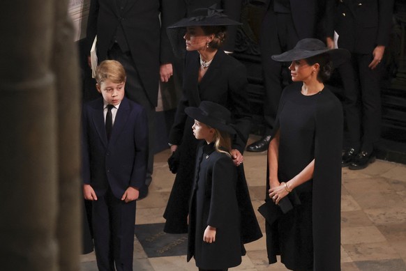 Britain's Kate, Princess of Wales, Meghan, Duchess of Sussex, Prince George and Princess Charlotte arrive at the Westminster Abbey for the funeral of Queen Elizabeth II, in London, Monday Sept. 19, 20 ...